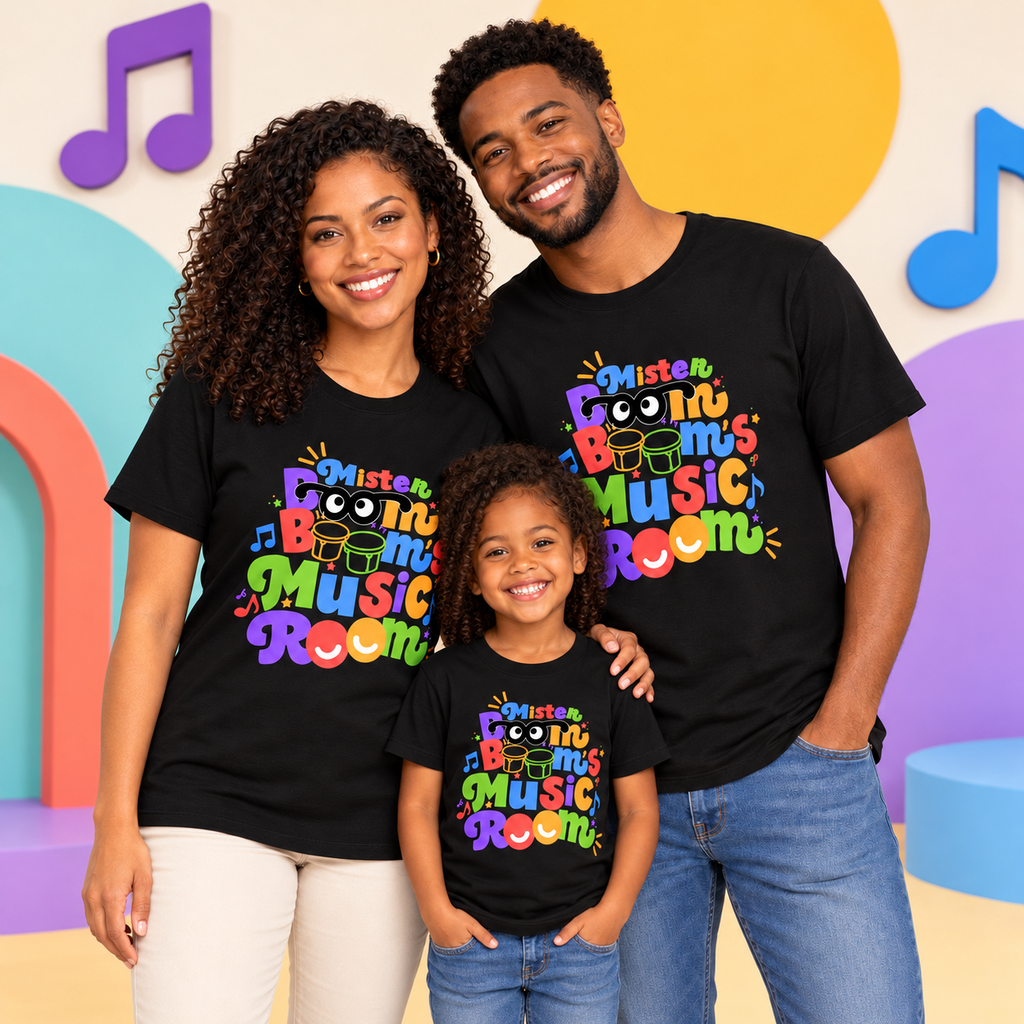 Two adults and a child wearing matching black Mister Boom Boom’s Music Room logo T-shirts in a colorful music-themed setting.